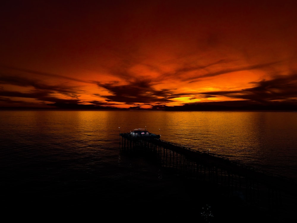 silhouette of dock during sunset