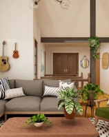 white and black sofa near brown wooden coffee table