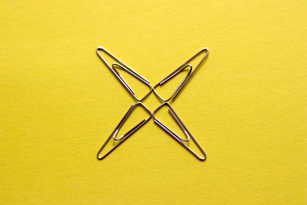 yellow paper clip on yellow surface