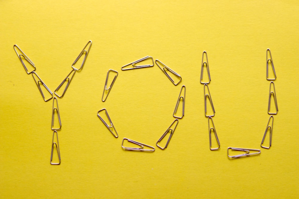 silver framed eyeglasses on yellow surface