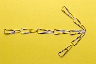 silver paper clip on yellow textile