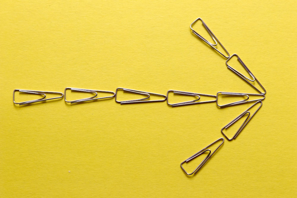 silver paper clip on yellow textile