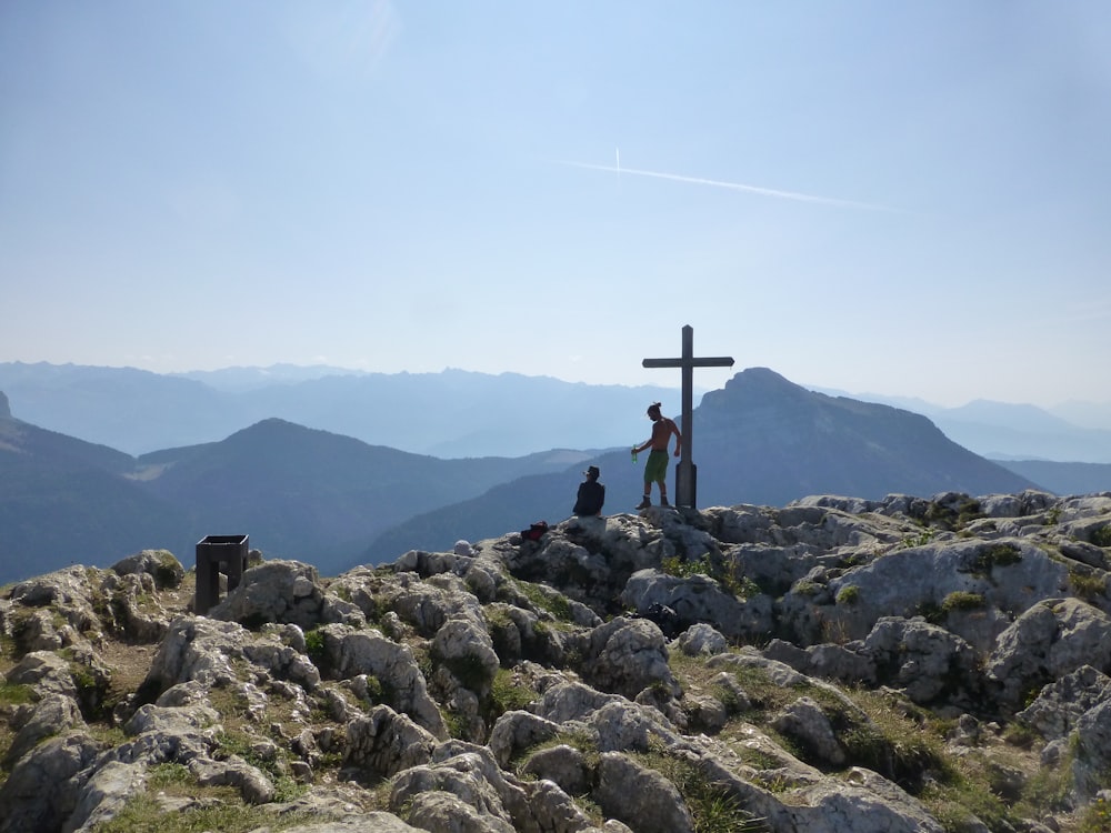 person standing on rocky mountain during daytime