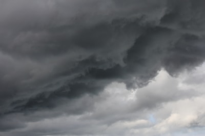 Dark, ominous clouds dominate the sky, hinting at the impending arrival of a storm, with lighter patches visible in certain areas.