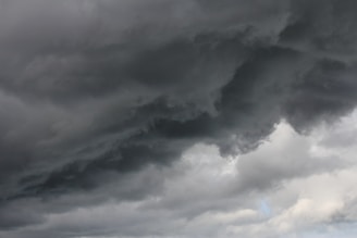 Dark, ominous clouds dominate the sky, hinting at the impending arrival of a storm, with lighter patches visible in certain areas.