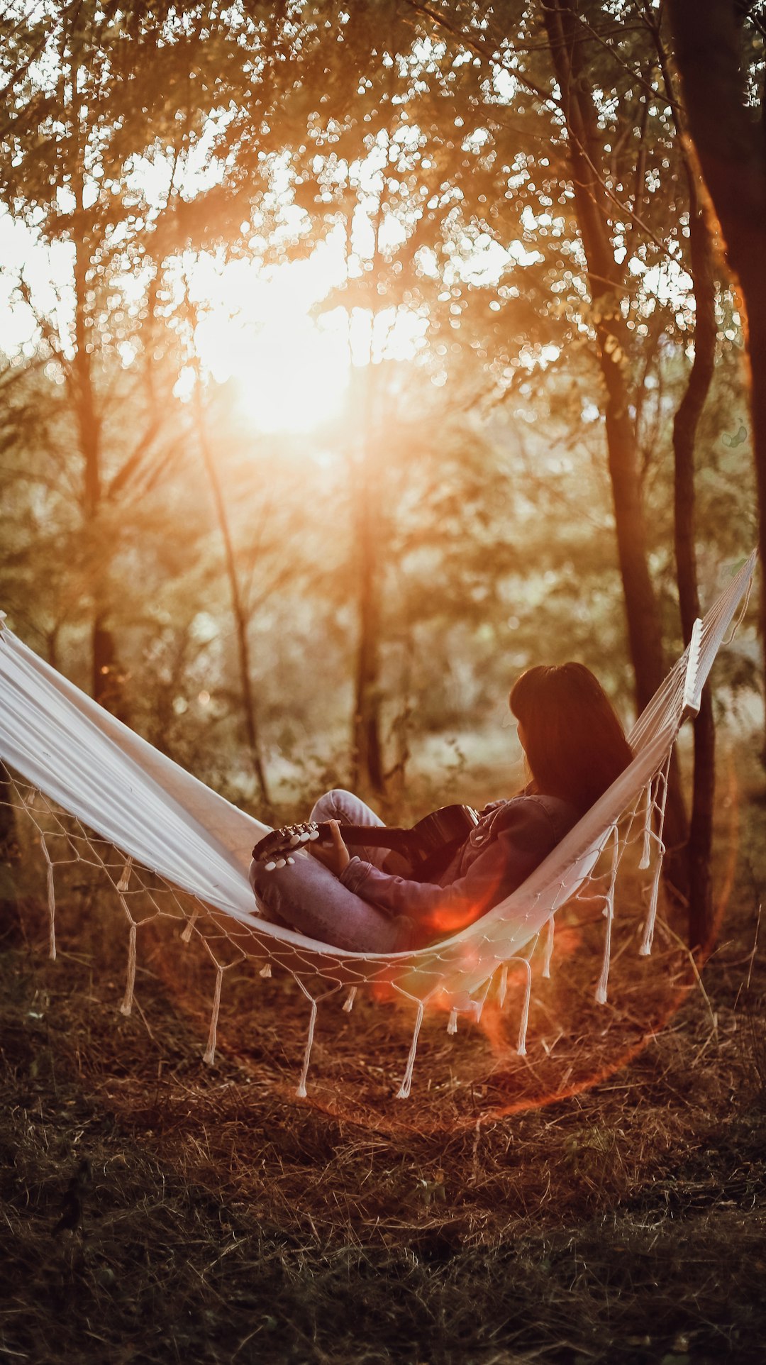 woman lying on hammock during daytime