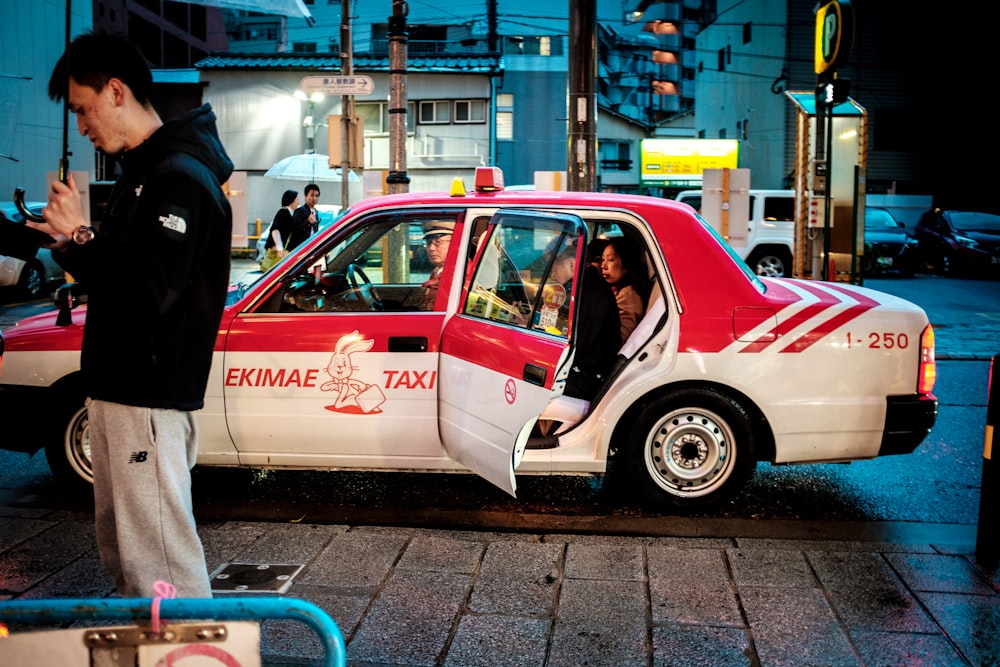 white and red sedan on road during night time