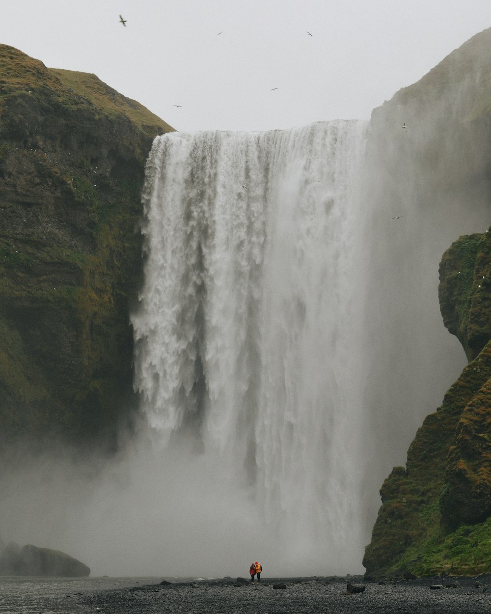 waterfalls on brown rocky mountain during daytime