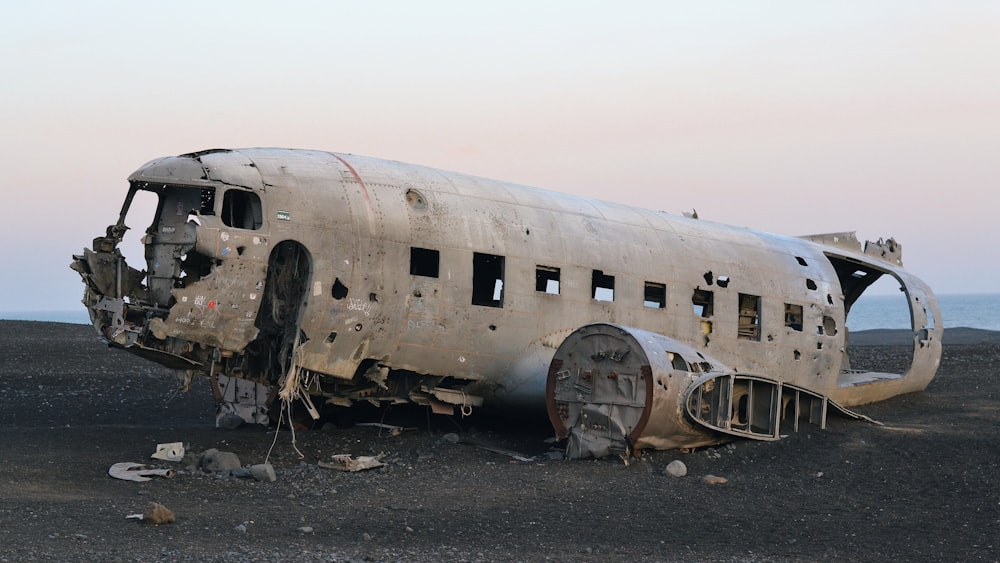 wrecked white airplane under white sky during daytime