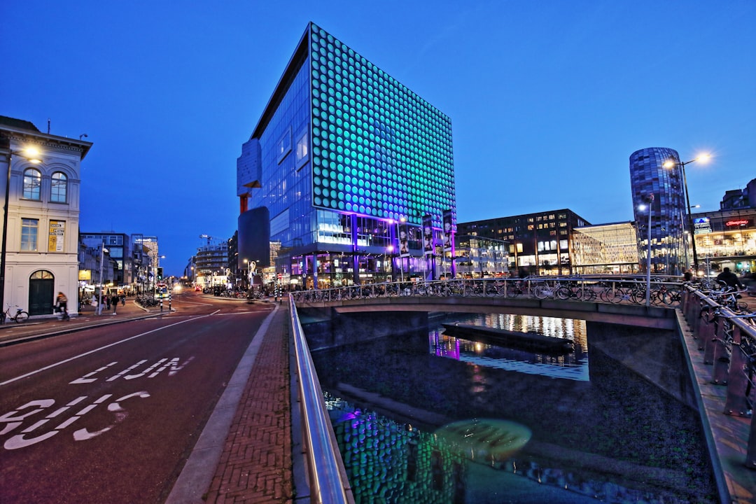 city buildings near body of water during night time