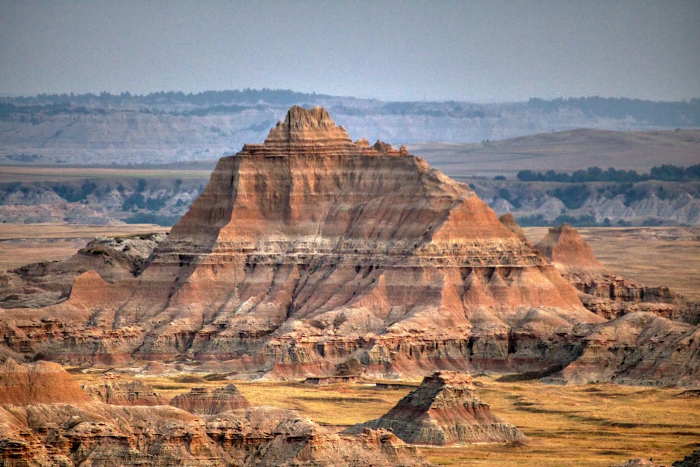 brown rock formation near body of water during daytime