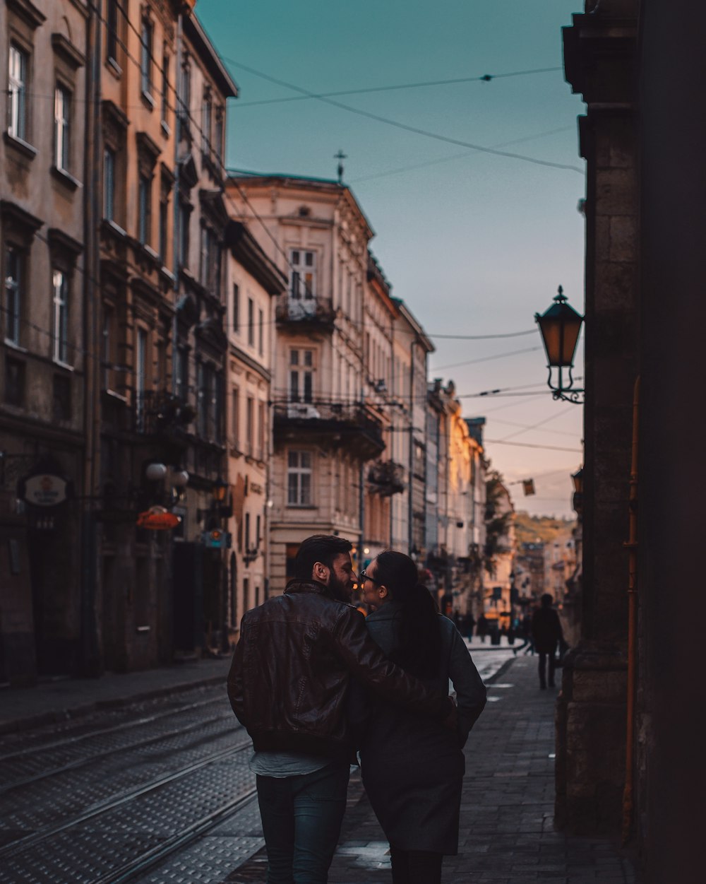 man in black jacket walking on street during daytime