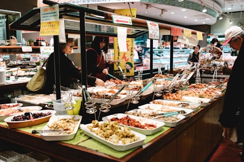 people sitting on chair in front of table with foods