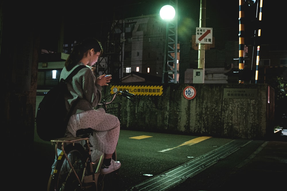 man in black jacket sitting on chair playing saxophone