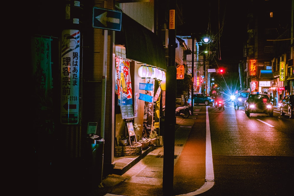 people walking on sidewalk during night time