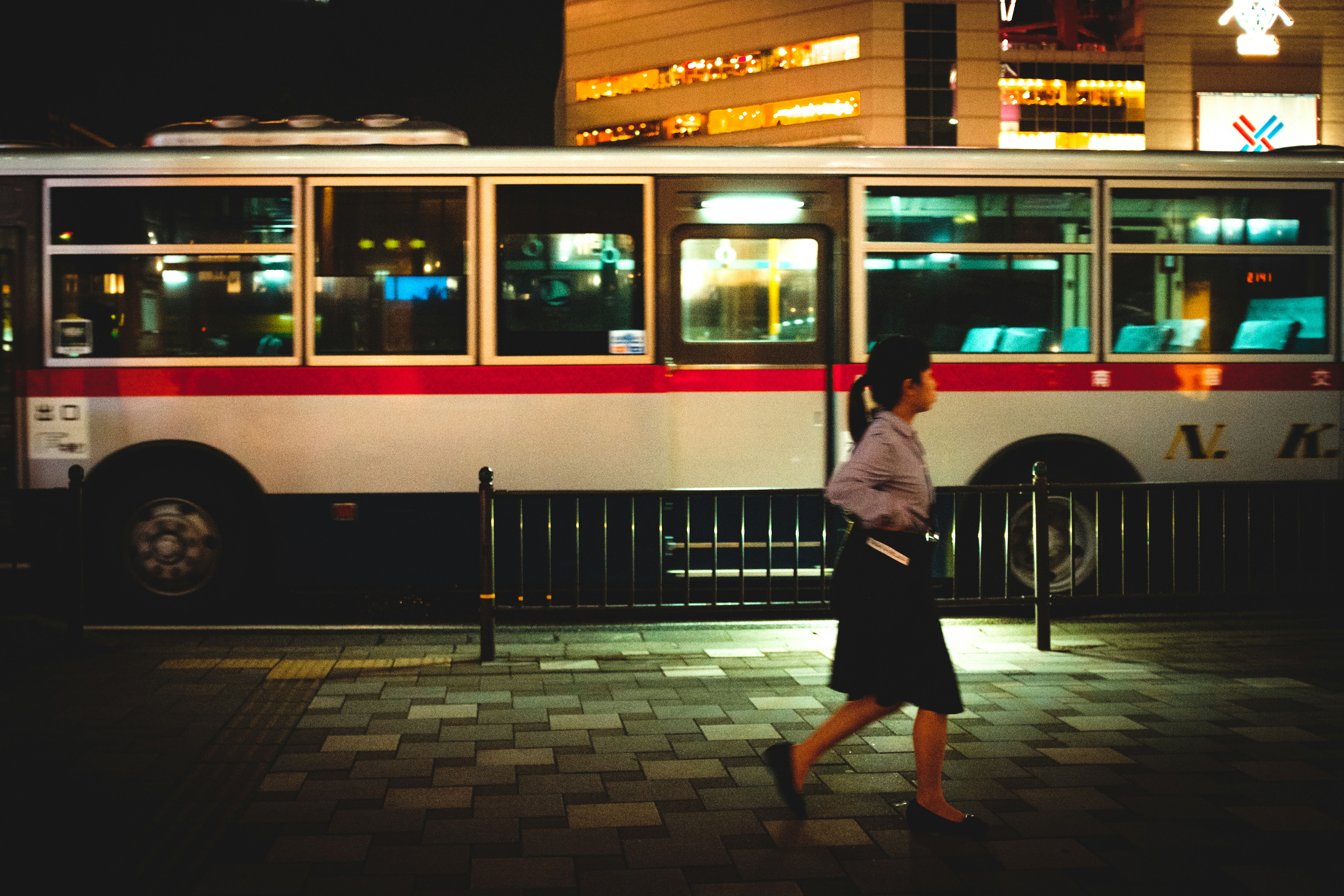 A woman confidently walking towards a bus, symbolizing empowerment, independence, and new opportunities.