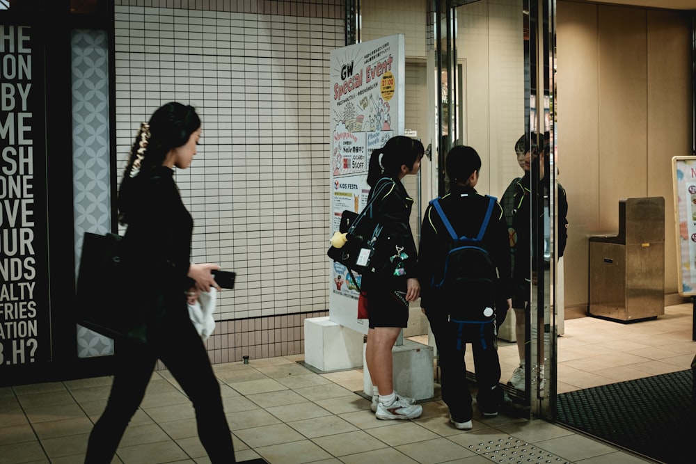 man in black and blue jacket standing beside woman in black jacket