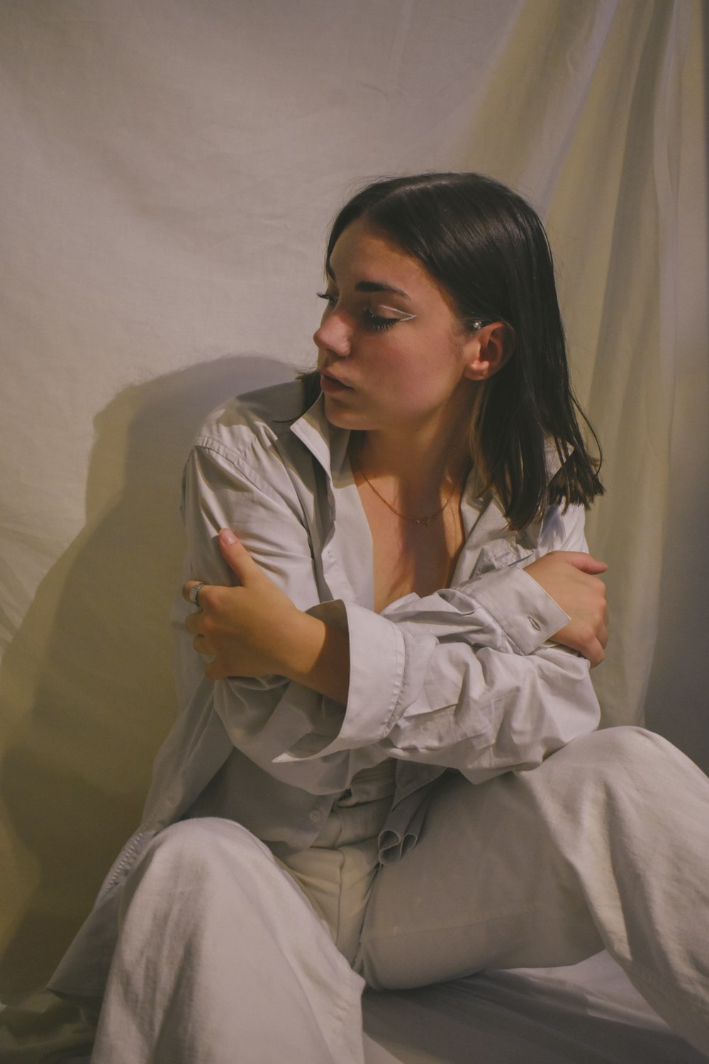 woman in white button up shirt sitting on chair