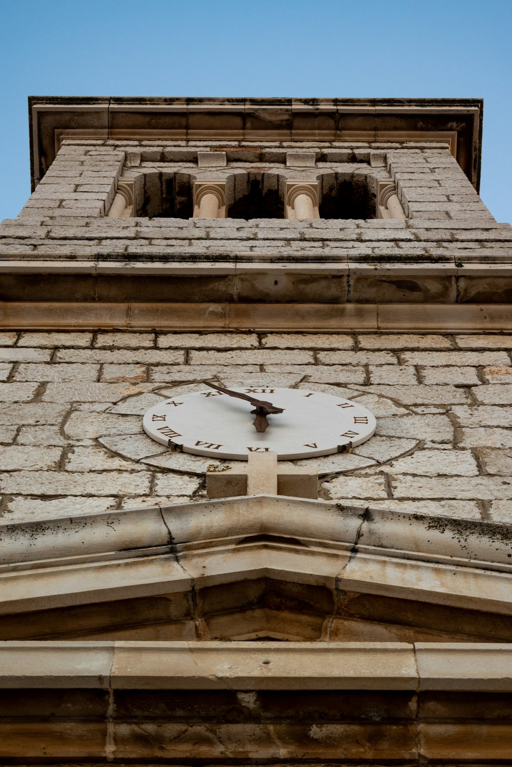 brown brick building with analog wall clock