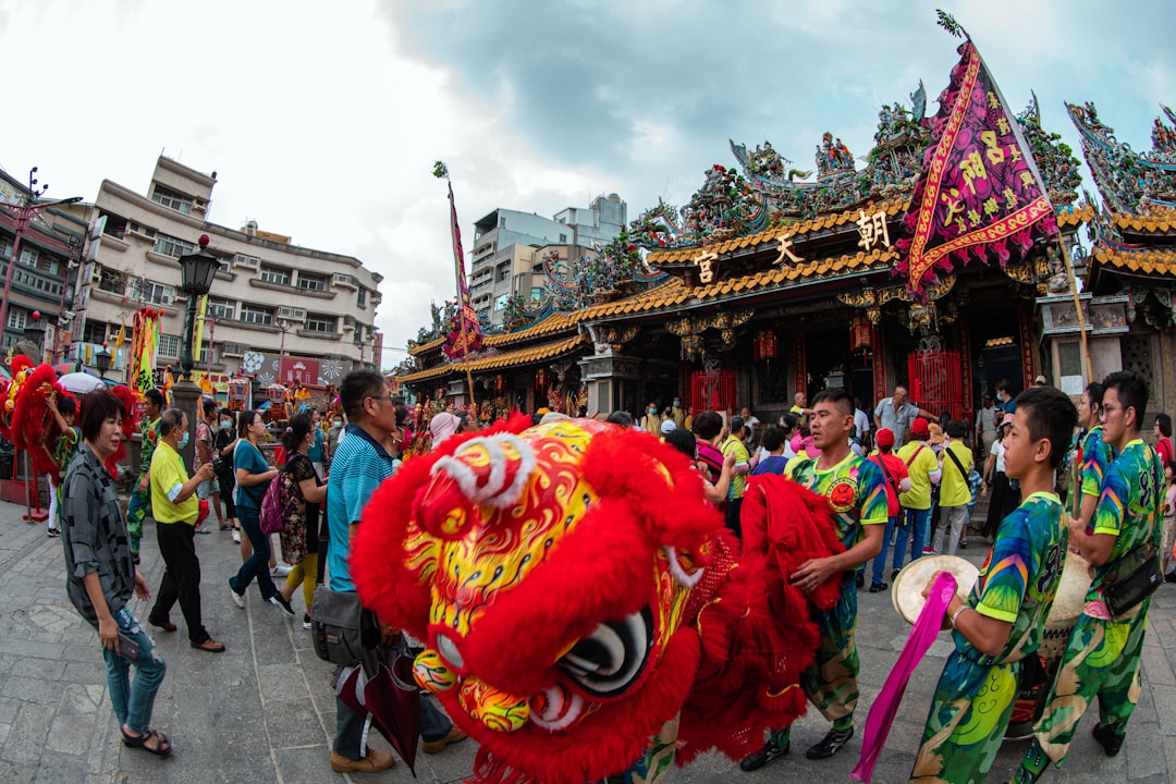 people in red yellow and green floral costume walking on street during daytime