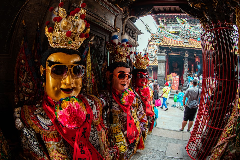 people in red and yellow traditional dress walking on street during daytime