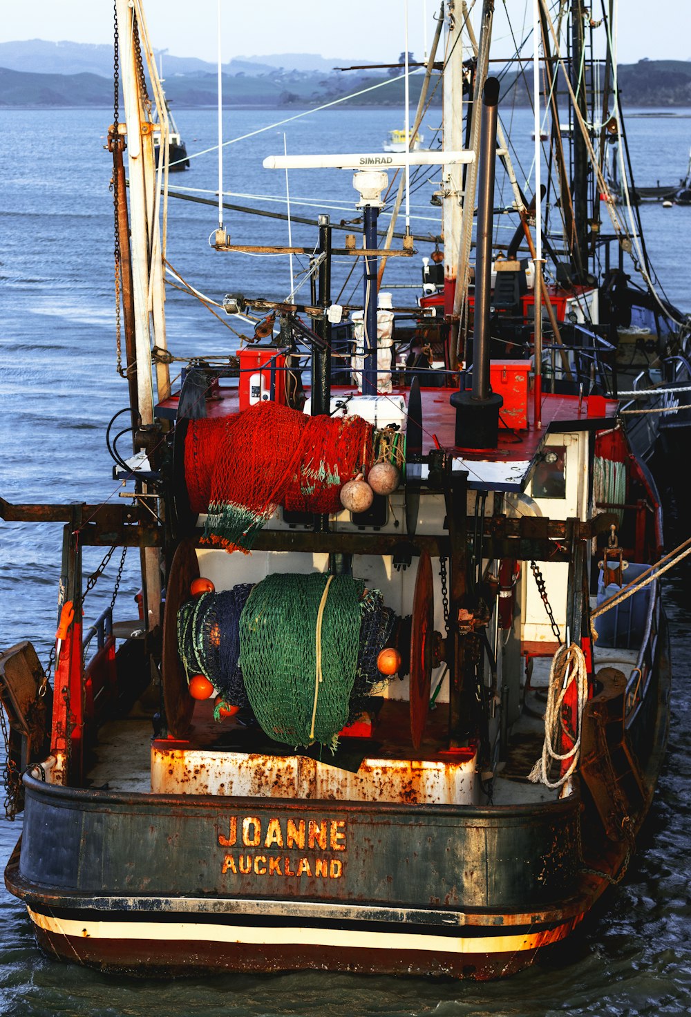 red and black ship on sea during daytime