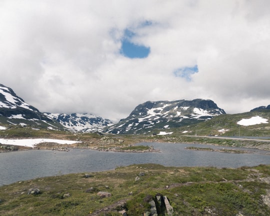 snow covered mountain under cloudy sky during daytime in Hardangervidda Norway