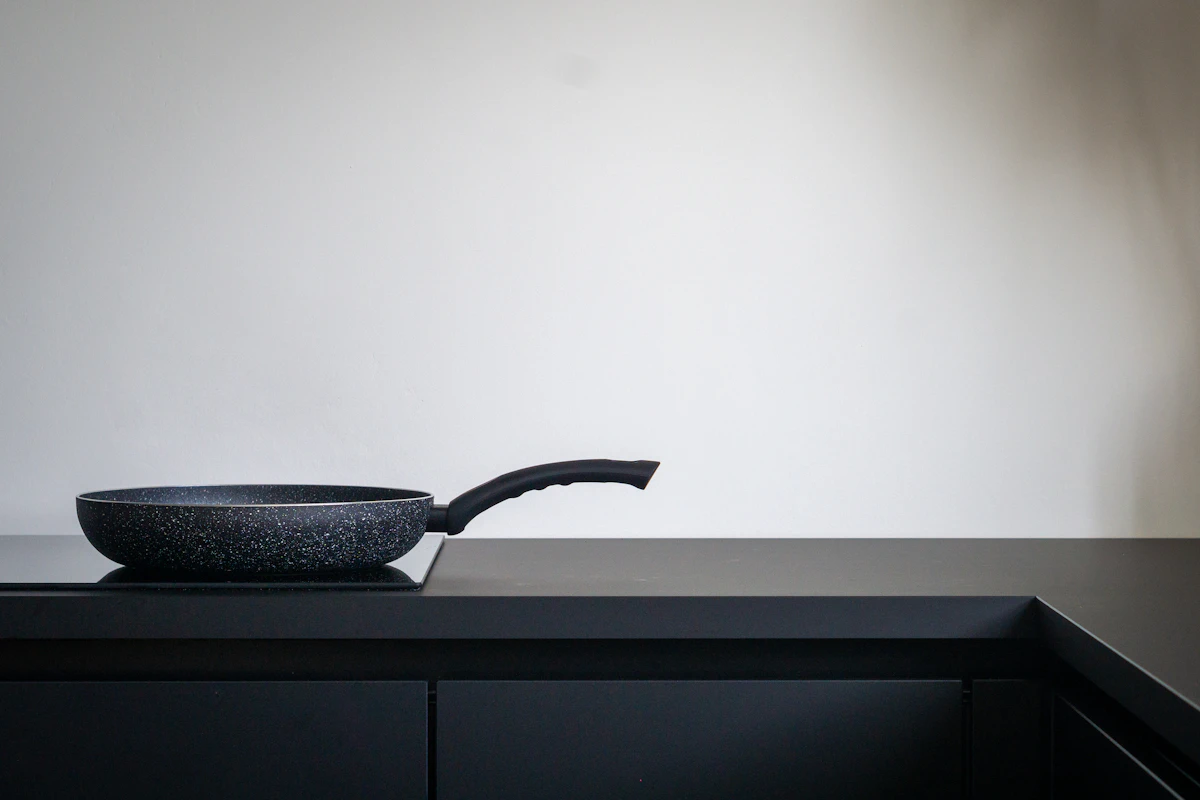 A single sauté pan resting on a clean, minimal kitchen counter