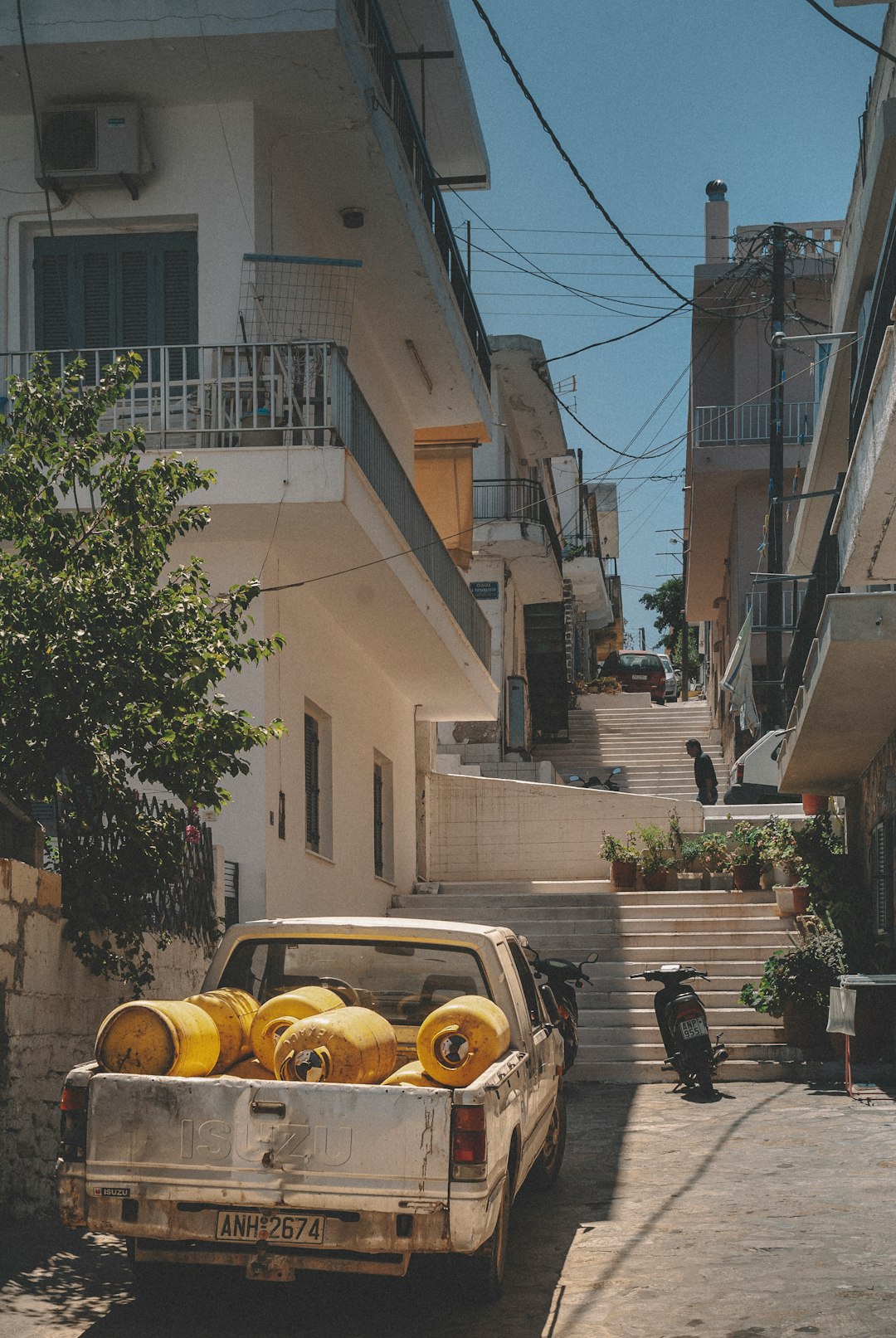 yellow car parked beside brown building during daytime