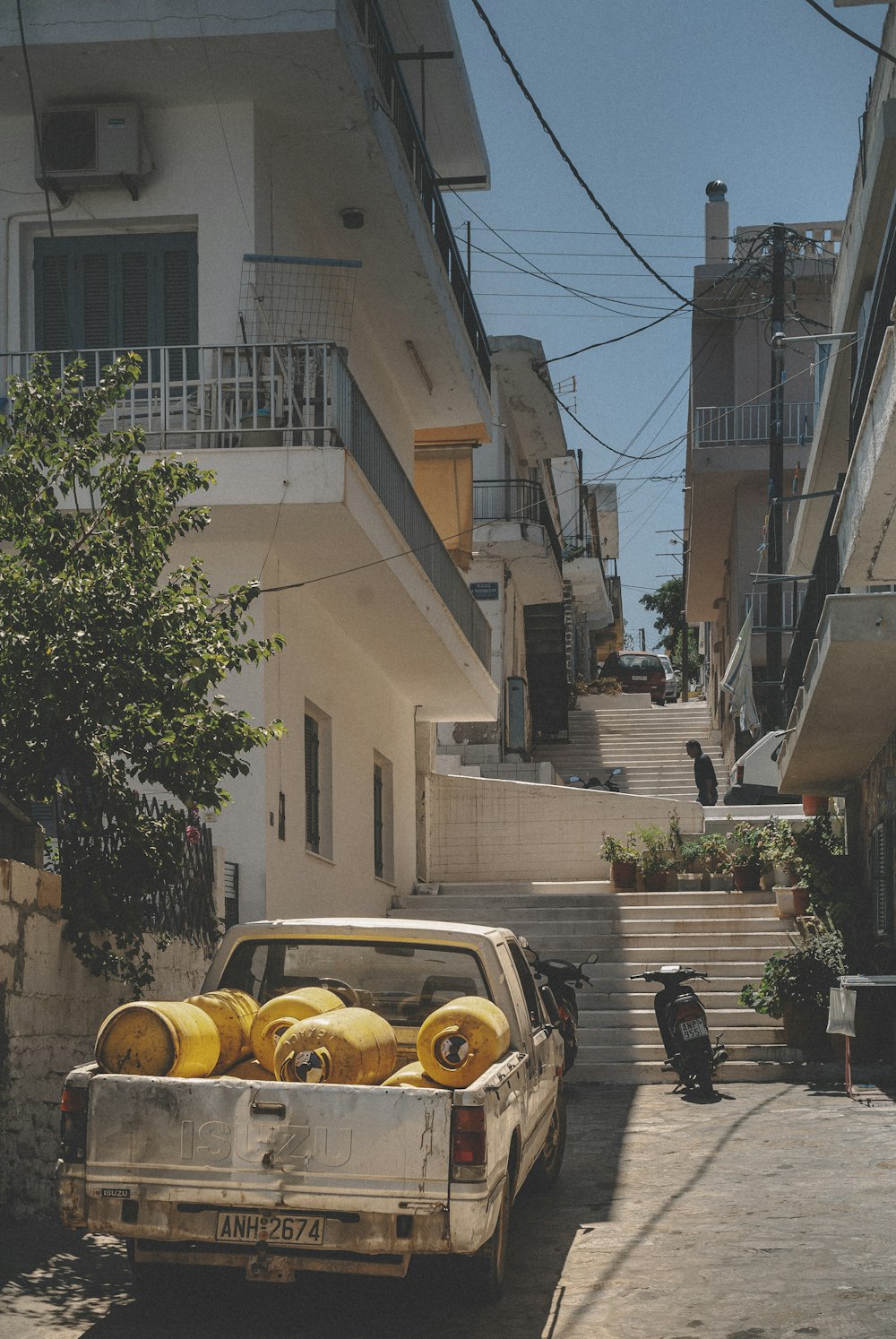 yellow car parked beside brown building during daytime