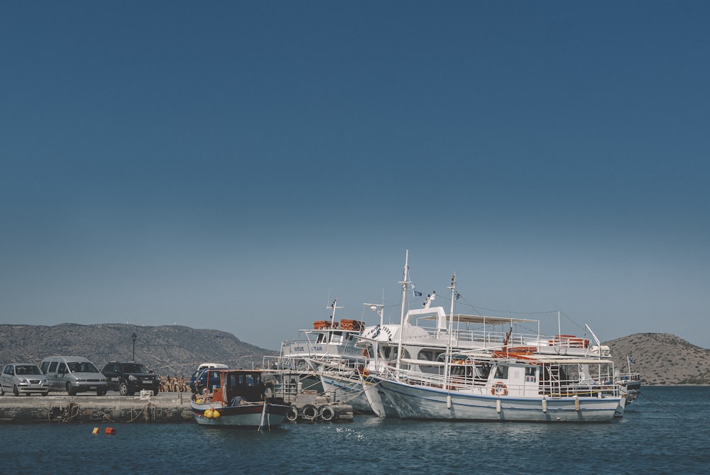 white and red boat on sea during daytime