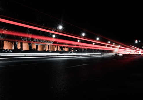 red bridge with lights during night time