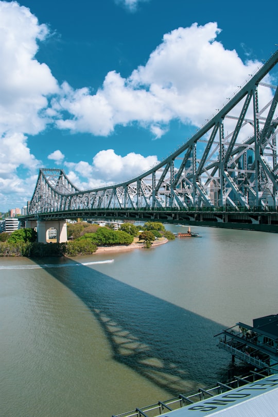 gray metal bridge over river under blue sky and white clouds during daytime in Story Bridge Australia