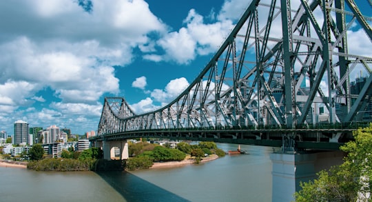 gray metal bridge under blue sky and white clouds during daytime in Story Bridge Australia