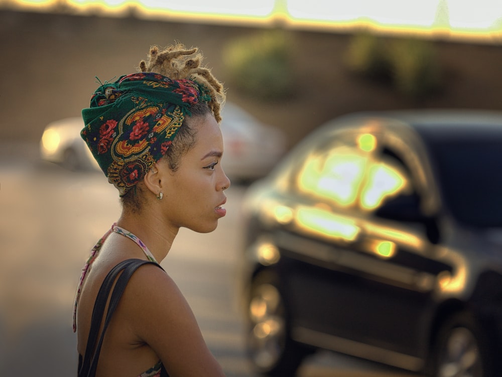 woman in black tank top wearing green and yellow floral headdress