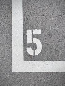 white and black 2 print on gray concrete floor