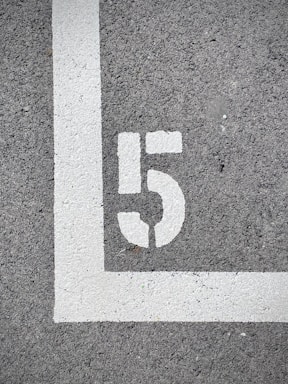 white and black 2 print on gray concrete floor