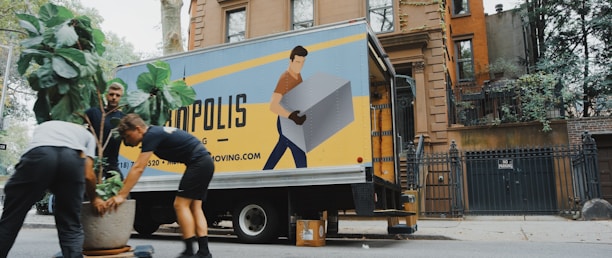 woman in blue shorts and black boots standing beside yellow and white truck during daytime