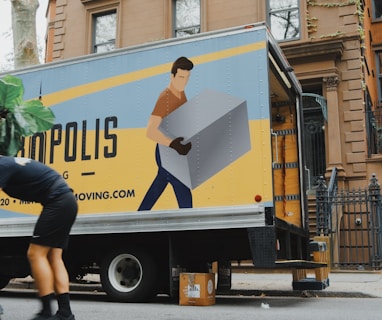 woman in blue shorts and black boots standing beside yellow and white truck during daytime