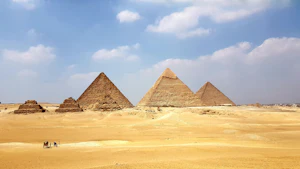 Pyramids of Giza under a blue sky