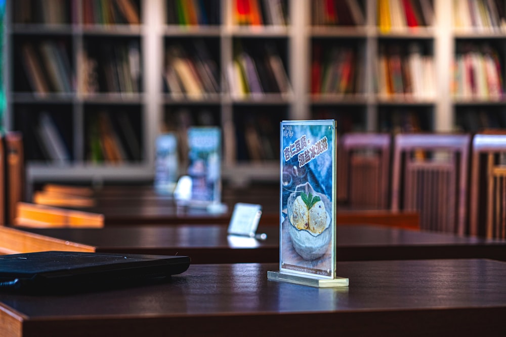 blue and white trading card on brown wooden table