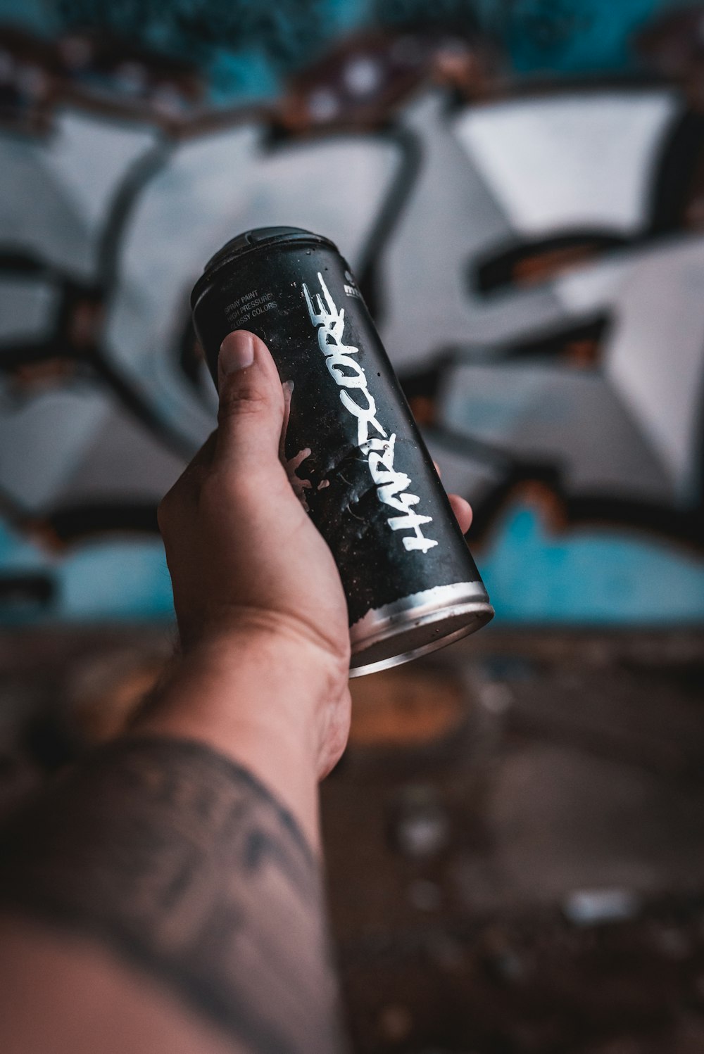 person holding black coca cola can