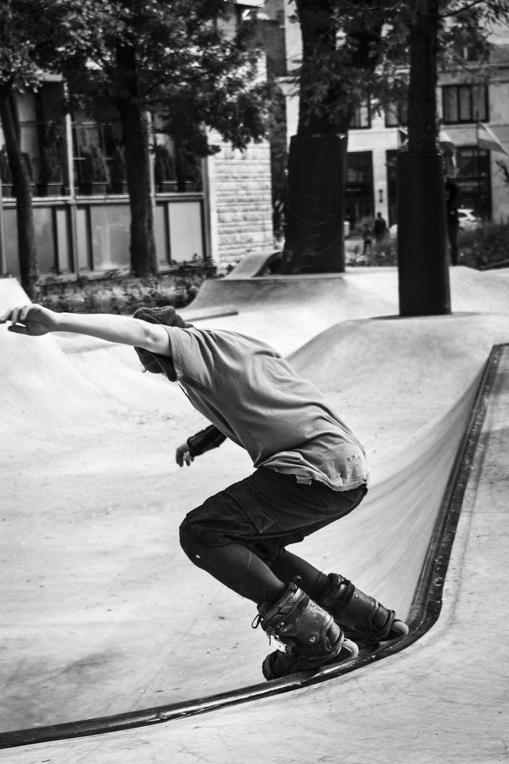 man in white t-shirt and black pants riding skateboard