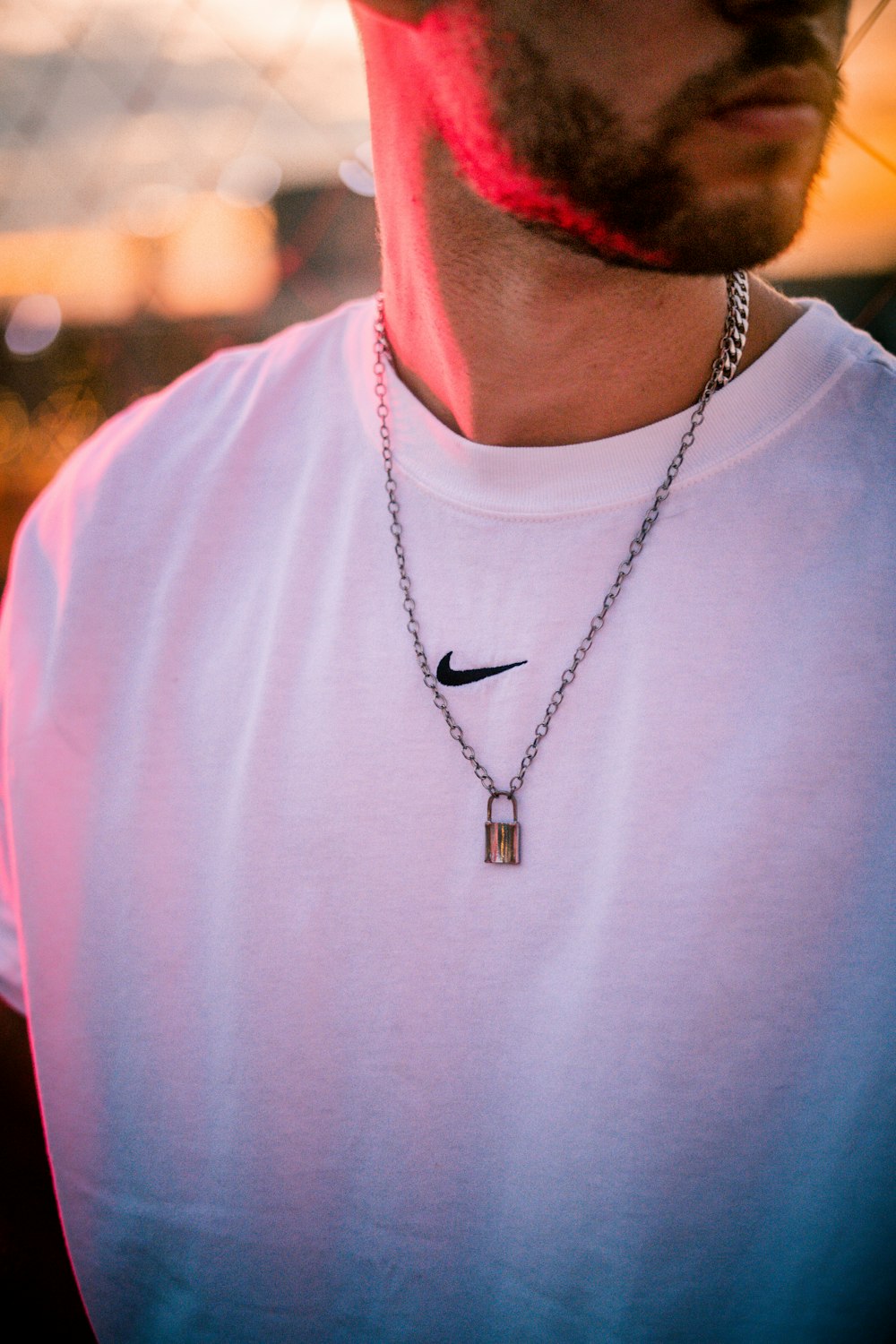 man in white crew neck shirt wearing silver necklace
