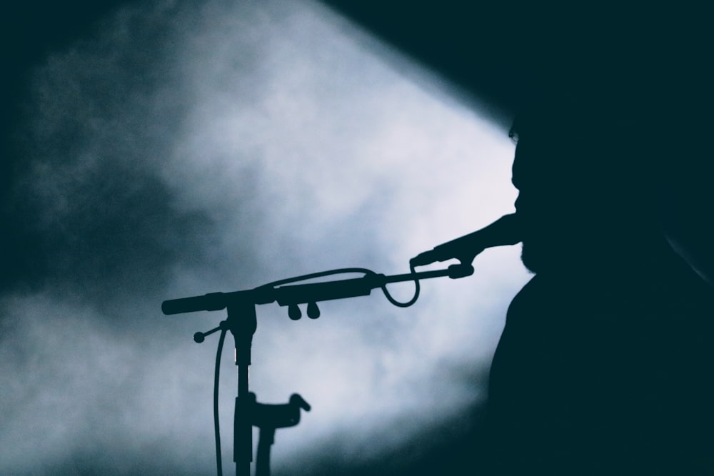 silhouette of man holding rifle