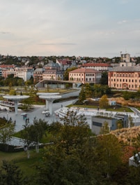 A panoramic view of a lively urban park surrounded by renovated buildings.