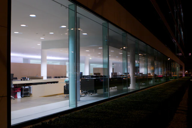 Dark Glazing with Green Wall — commercial glass partition interior design
