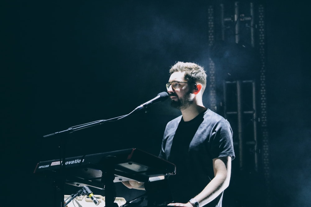 man in black crew neck t-shirt playing piano