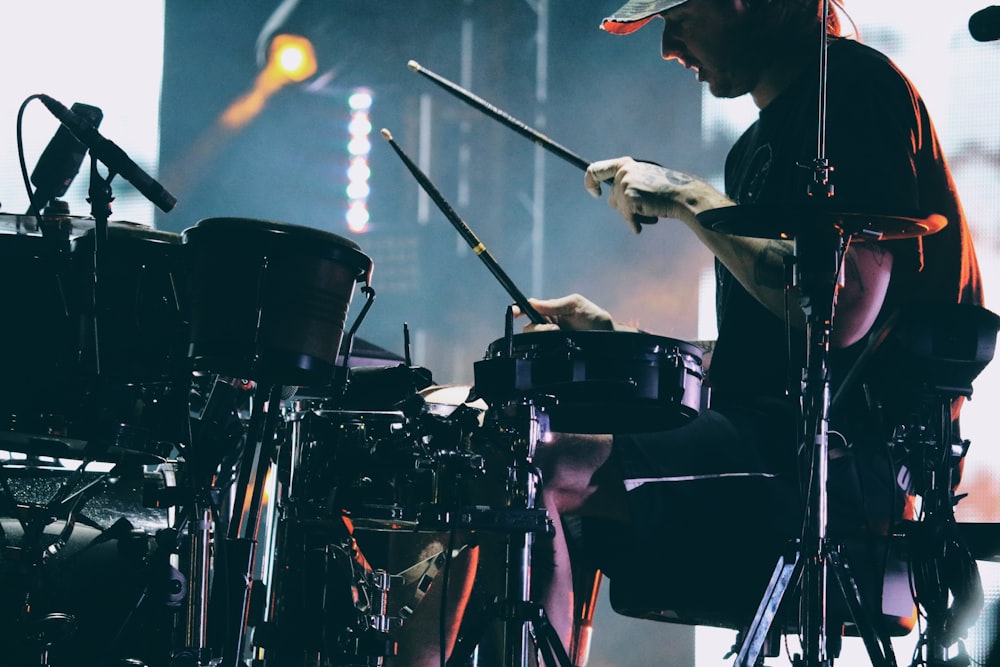 man playing drum on stage