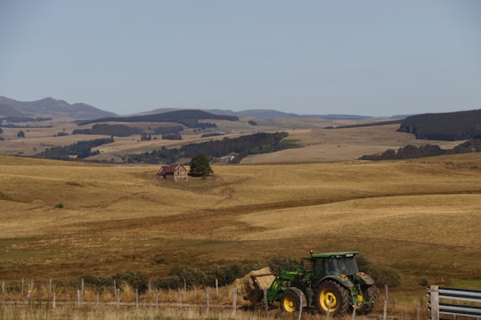 green tractor on brown field during daytime in Auvergne France